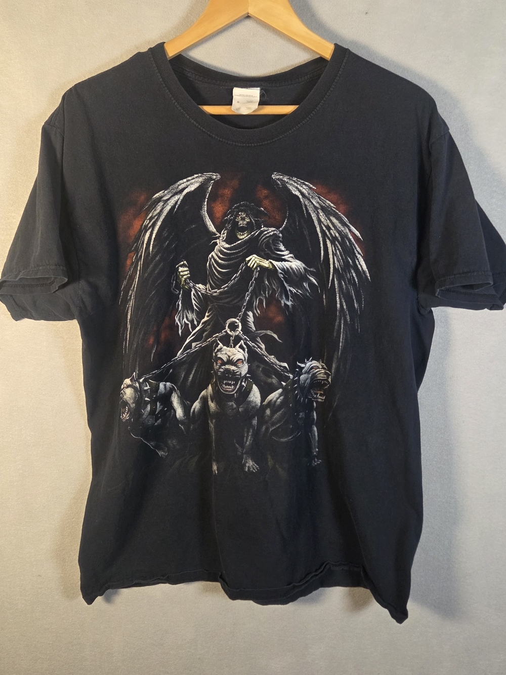 graphic of a winged grim reaper holding three dogs (S593)